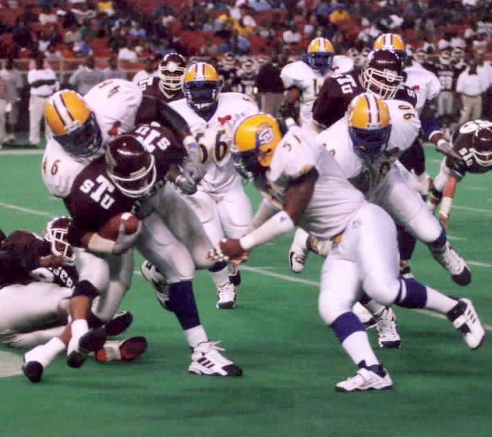 The SU "Dog Day Defense" led by #51 Shannon Smith, #46 Michael Landry and #90 Alex Coleman tackles a TSU running back. Photo by Brandi Jade Thomas/DIGEST