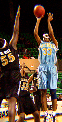 Ruth Buck, forward from Port Gibson, Miss., jumps over the 6-foot-5 center for Alabama State