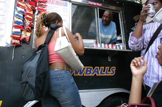 Owner/operator Jeff Thomas extends "Southern Hospitality" to a customer at the window of his mobile restaurant. - PHOTO BY DOUGLAS TOUSSAINT//DIGEST