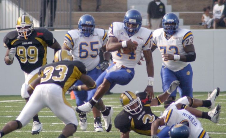 QB Thomas Ricks hops over Hornet defenders on a quarterback keep. Ricks finished the game 24 of 38 for 407 yards and five touchdowns including one touchdown reception. - PHOTO BY DOUGLAS TOUSSAINT//DIGEST