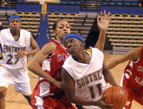 A focused Rolanda Monroe weaves through the USA defense for a shot in the second half of Thursday's game.