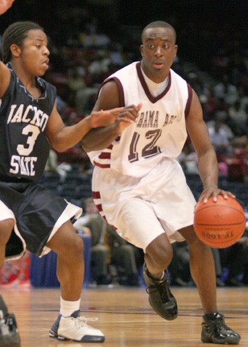 Alabama A&amp;M guard Obie Trotter drives past Catraiva Givens of Jackson State. Trotter, the SWAC player of the year, finished the game with 15 points and six rebounds. PHOTO BY JOSH HALLEY