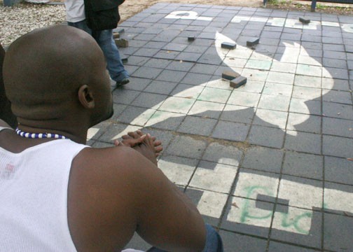 Genael Moore stares disgustedly at the vandalized Phi Beta Sigma/Zeta Phi Beta plot. In addition to the Zeta's dove being spray painted, the surrounding benches and trees were also spray painted and some of their bricks were broken. PHOTO BY JOSH HALLEY