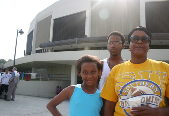 New Orleans homemaker Vaness Hoffman stands with her two children outside the F.G. Clark Activity Center (Minidome) on the Southern University campus in Baton Rouge. The Minidome has been converted into a shelter for housing evacuees from areas decimated