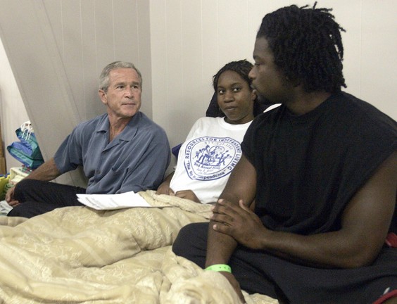 President Bush sits with Ailisa Eugene and Frank Jack at the make shift shelter at Bethany World Prayer Center , Monday, Sept. 5, 2005, in Baton Rouge, La. The couple, from Metairie, La., was displaced by Hurricane Katrina and are expecting a baby in Nove