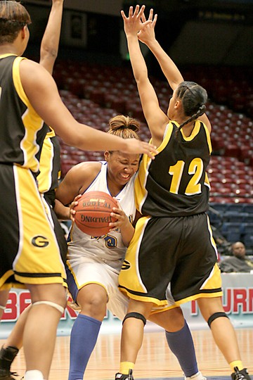 Jaguars' sophomore forward Krystal Huggins struggles to keep possession of the ball after snatching one of her six rebounds against the Grambling State Lady Tigers. (PHOTO BY JOSHUA L. HALLEY)