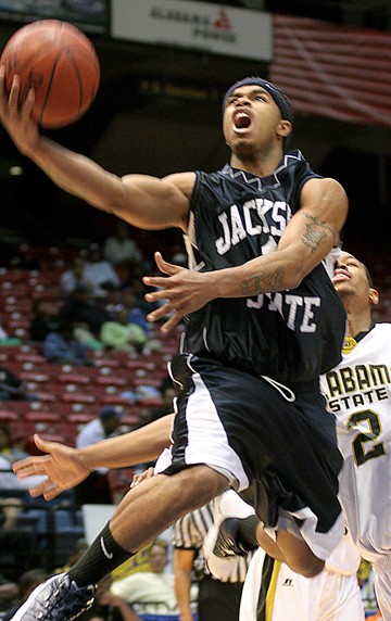 Jackson State's sophomore gaurd Charlie White goes up hard against Hornets freshman guard Andrews Hayles. (JOSHUA L. HALLEY)