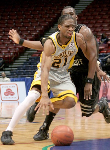 Grambling State junior guard Jarvis Gunter dribbles around a UAPB defender. (PHOTO BY JOSHUA L. HALLEY)