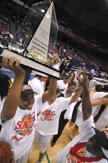 Ashley Blake holds the 2006 SWAC tournement championship trophy over her head while she an other members of the Southern University Lady Jaguars celebrate their victory. (DOUGLAS W. TOUSSAINT. JR)