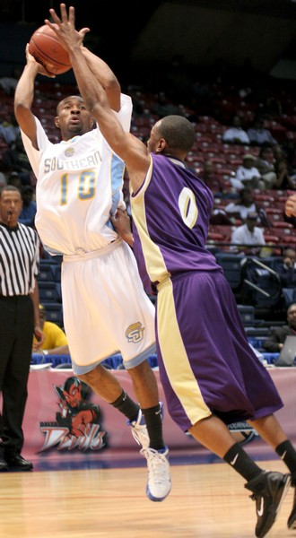 Jaguars' guard Chris Alexander elevates over Alcorn State defender Delvin Thompson to score two score of his 11 total points. Alexander only played 18 minutes due to the commanding and consistent lead the Jags held all game. (PHOTO BY JOSHUA L. HALLEY)