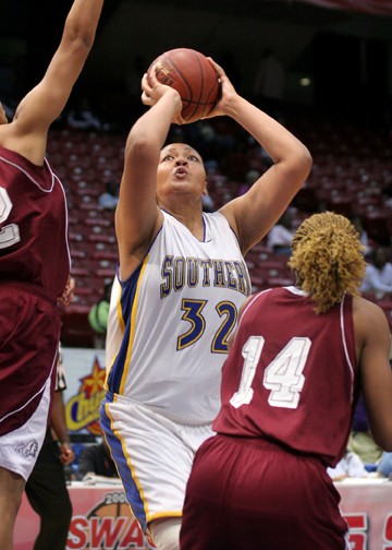 Jaguars' center Fredrieka Lewis shoots over two Lady Bulldog defenders to score two of her 13 points. Lewis also grabbed seven rebounds in the SWAC women's basketball semifinal game. (PHOTO BY JOSHUA L. HALLEY)