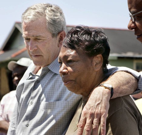 President Bush talks to the media with Ethel Williams, 72, in front of her home which is being repaired by volunteers from the Catholic Charities in the Upper Ninth Ward of New Orleans yesterday. Photo by The Associated Press