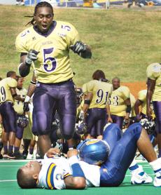 Edward Moore, defensive back for Prairie View, taunts Southern's Jarmaul George as the Panthers celebrate their overtime win over the Jaguars. Moore intercepted SU's J.C. Lewis on his first pass attempt of the football game.