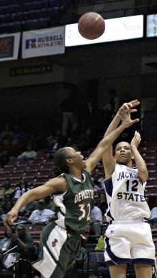Jackson State forward Carena Easley fires a shot over Mississippi Valley State forward Portia Wilson to score two of her 13 points during the JSU Lady Tigers 68-52 victory over the MVSU Devilettes on Wednesday night. Easley also pull down nine rebounds and grabbed two steals during the SWAC Basketball Tournament Quarterfinal Game.