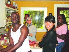 From left- Abdoulaye Seck, Alexis Price, Zainub Salem, Yun Zu, and Brittany Davis pause for a quick photo while preparing dishes for the cultural luncheon.