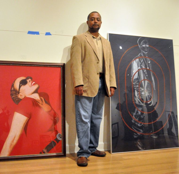 Jared Alcorn stands between "A Good Afternoon", left and "View of a Young Black Male" both are colored pencil on illustration board.