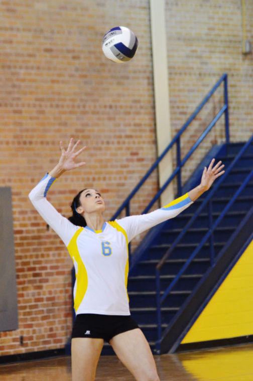 Middle blocker Deysia Burden throws up the ball for a serve in yesterday's game against McNeese State in Seymore Gym during the home opener.