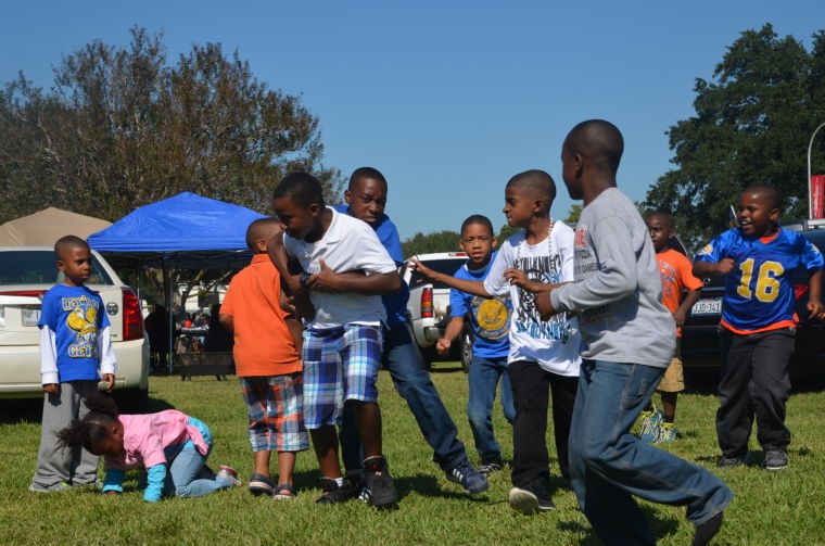 Little Jaguar fans playing football while enjoying Southern's Homecoming Saturday.