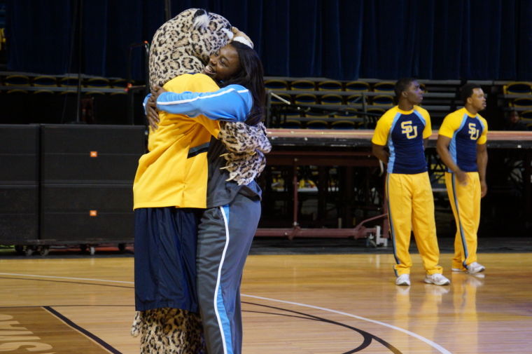 Senior guard Adrian Sanders gives Lacumba a hug after being introduce at the Jaguar Pandemonium Sunday at the F.G. Clark Activity Center