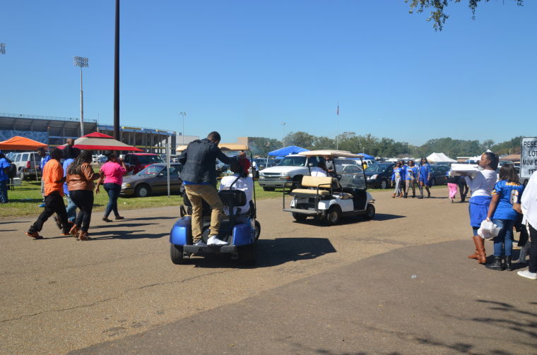 Fans riding carts around campus while enjoying the tailgating experience at Southern Saturday.