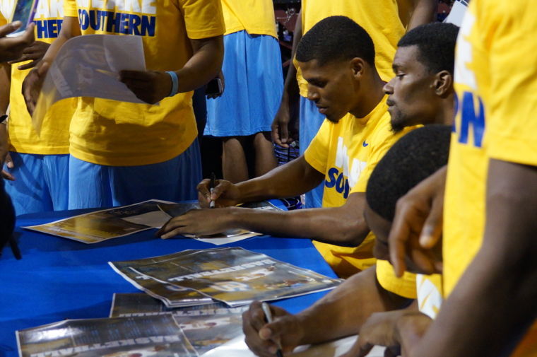 Members of the Jaguar basketball team sign autographs to fans during Sunday night's Jaguar Pandemonium at the F.G. Clark Activity Center.