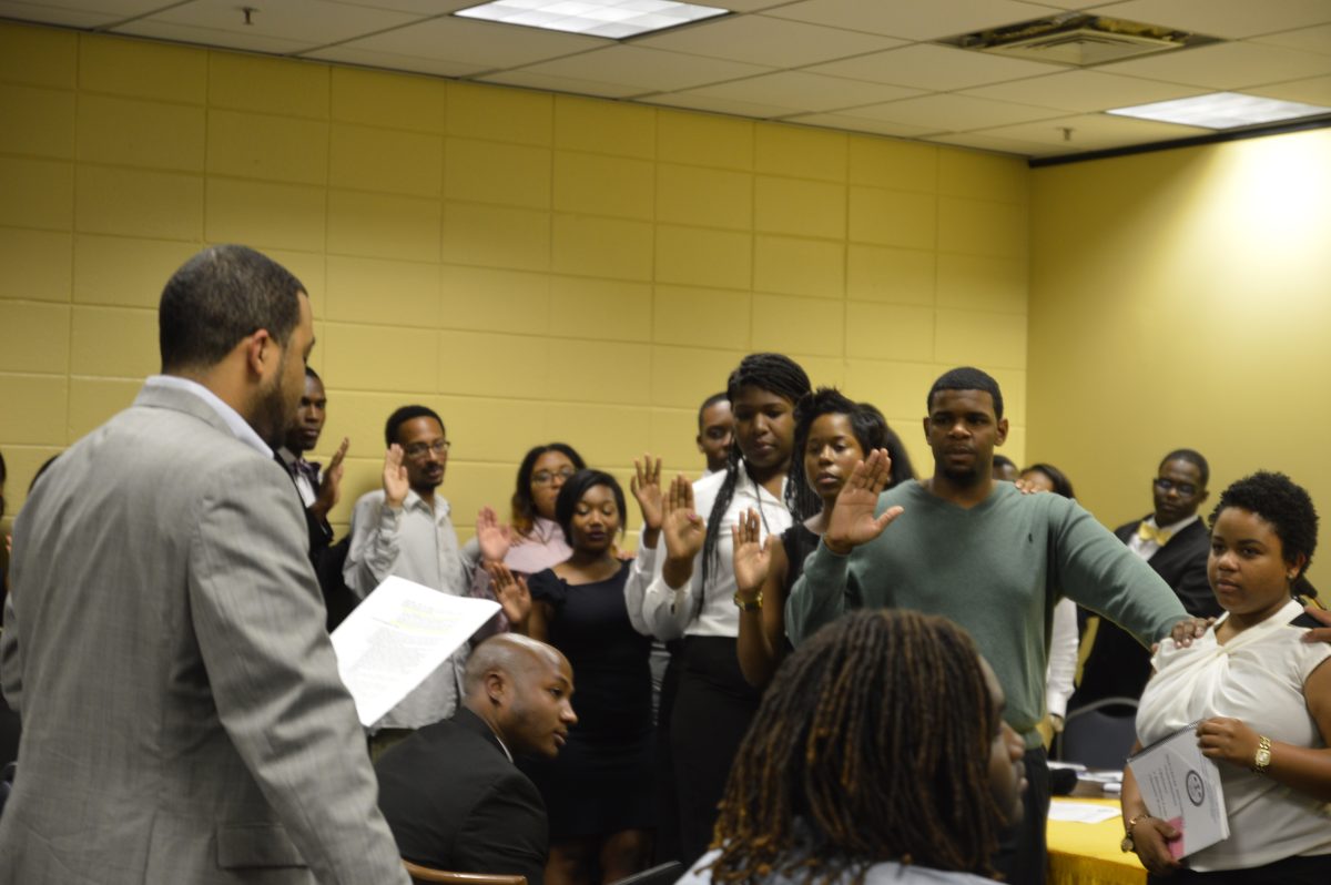 Dean of Students Marcus Coleman swears in the newly&#160; elected SGA Officers at the SGA Senate Meeting held&#160; last Thursday, September 18, 2014.