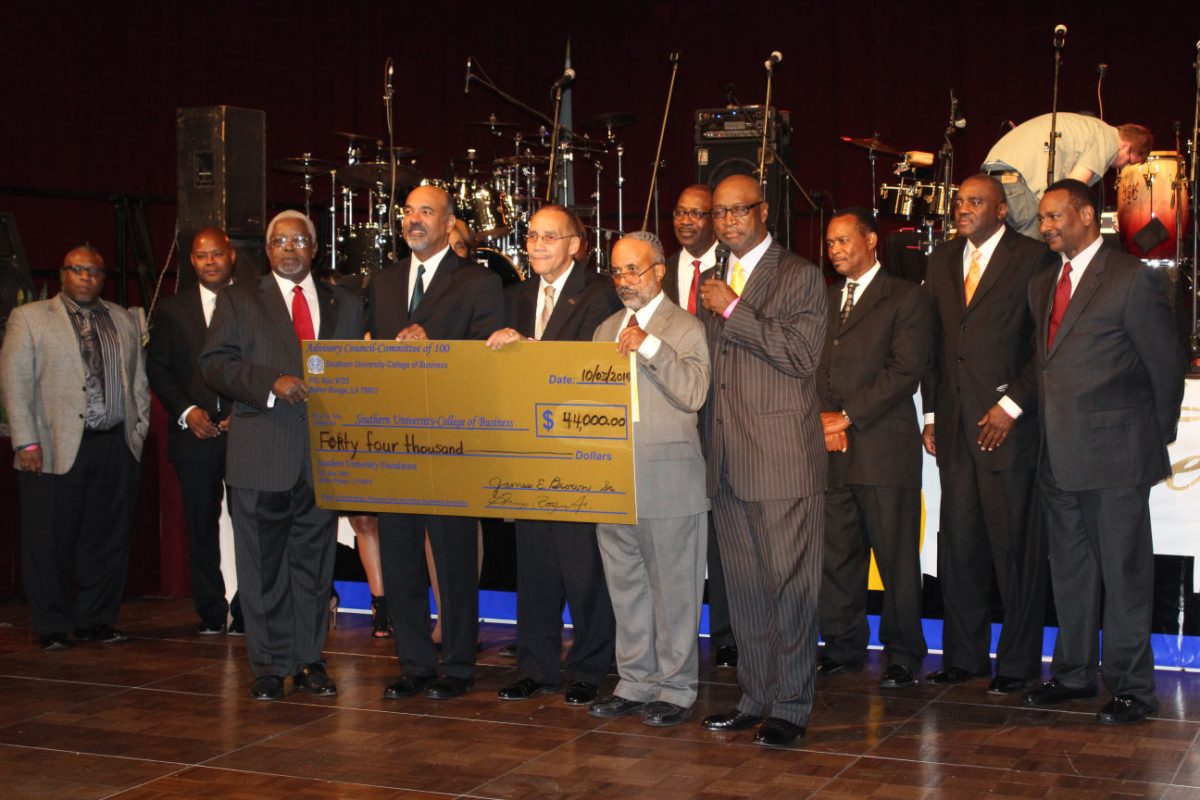 Ronald Mason, Southern University System President, stands along side acting Chancellor Flandus McClinton, Jr. and Donald Andrews, Dean of the College of Business, as they accept a check from various sponsers of Southern University for $44,000.