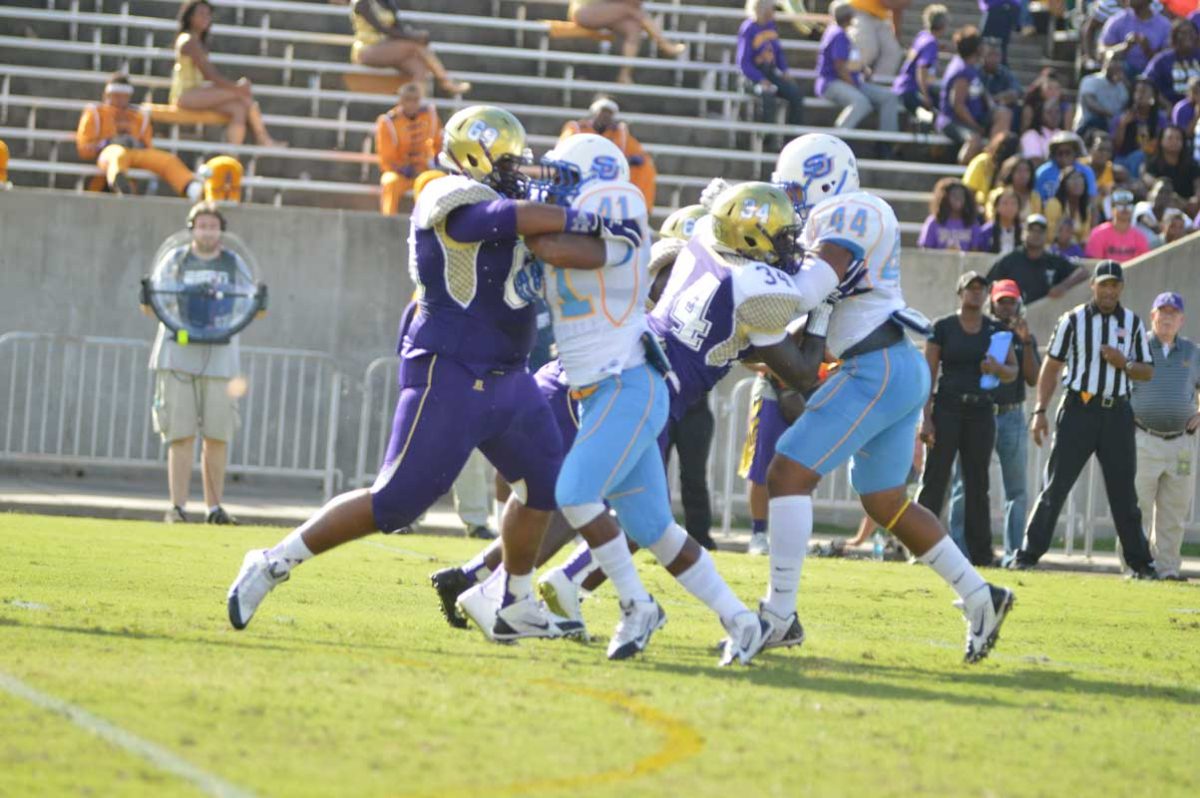 Freshman linebacker Lemar Martin and freshman linebacker Jordan Taylor hold down Alcorn's offense during the SU vs. Alcorn State game Saturday, September 27, 2014.