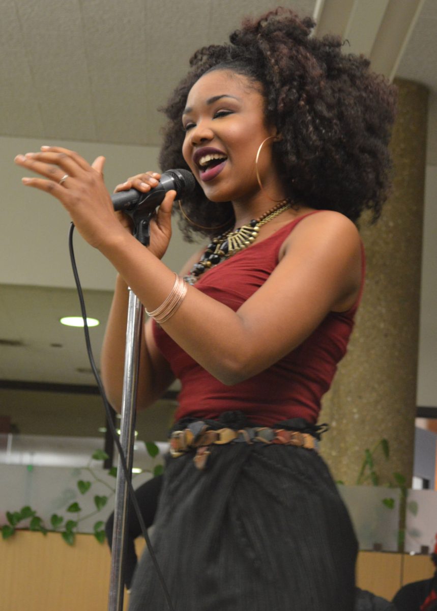 Che'Von Allen, Sigma Alpha Iota member, harmonizes on the mic during the SAI's "Groove Lounge" in java city, friday.