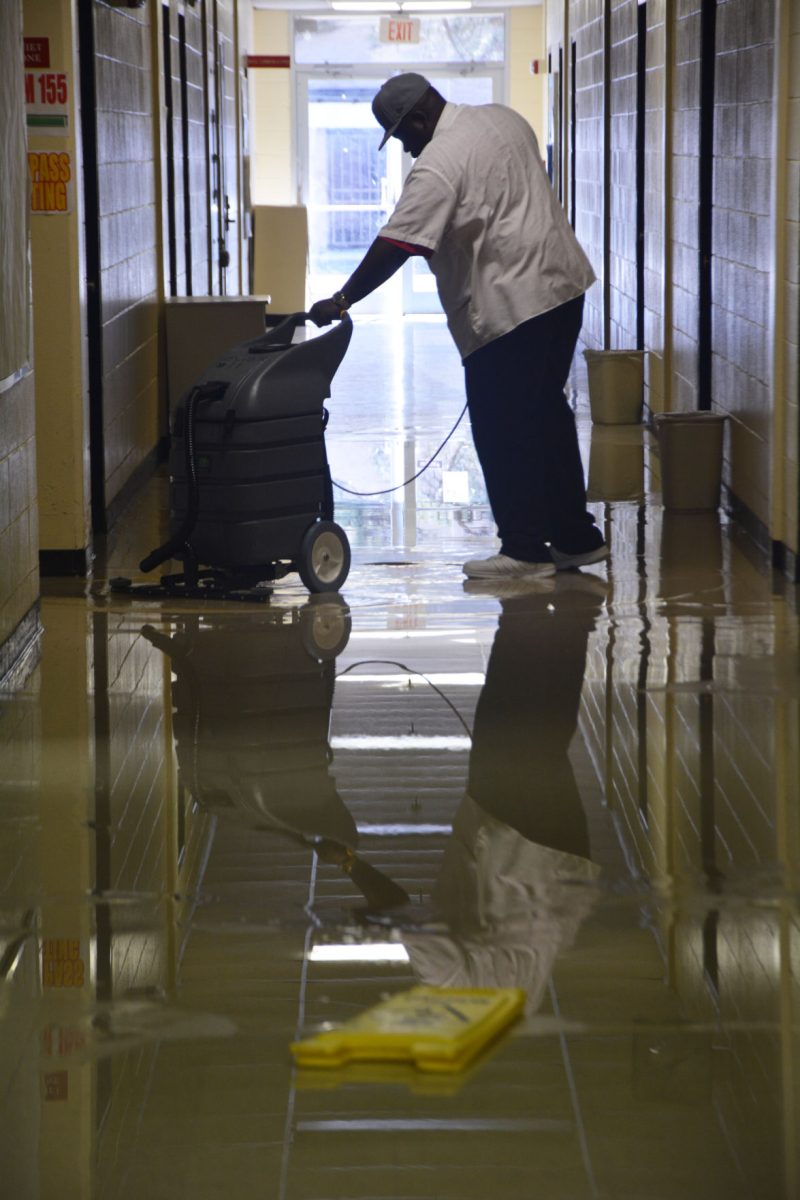 A Southern University Janitor works tediously to remove the water that flooded Stewart Hall, on Friday, February 6, 2015.