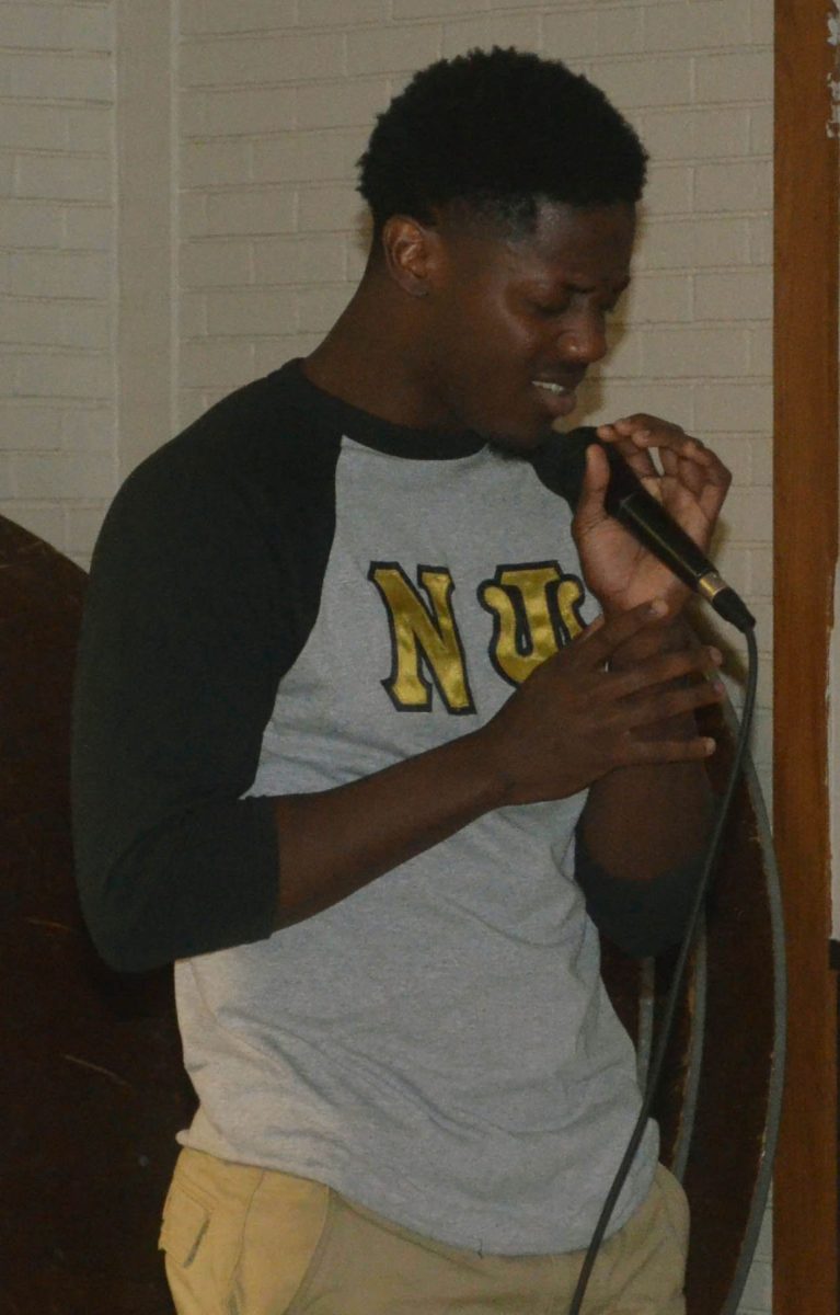 LSU member of Alpha Phi Alpha Fraternity Inc. Seanil Reed passionately recites his poetry at the AKA's Harlem Nights Casino and Lounge.