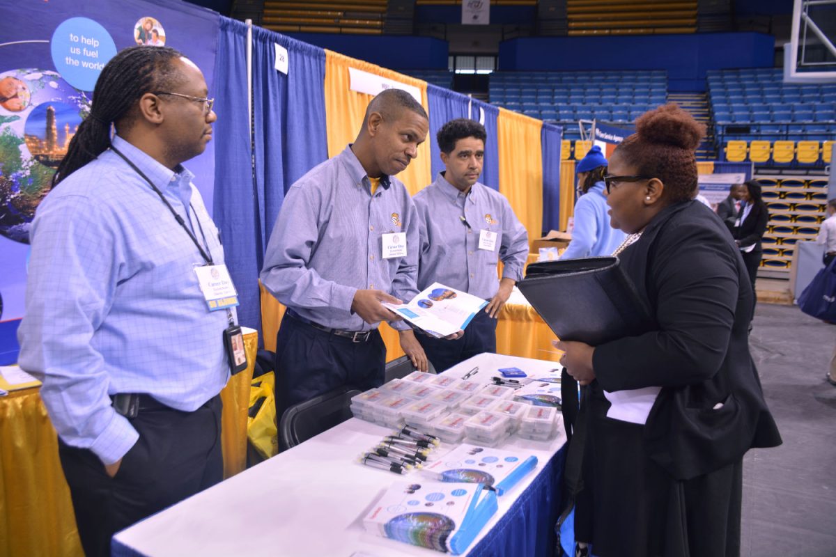 Exxon Mobil Representative and SU Alumni, Lenard Tillery, and colleges speak to student during the Spring 2015 Career Fair.