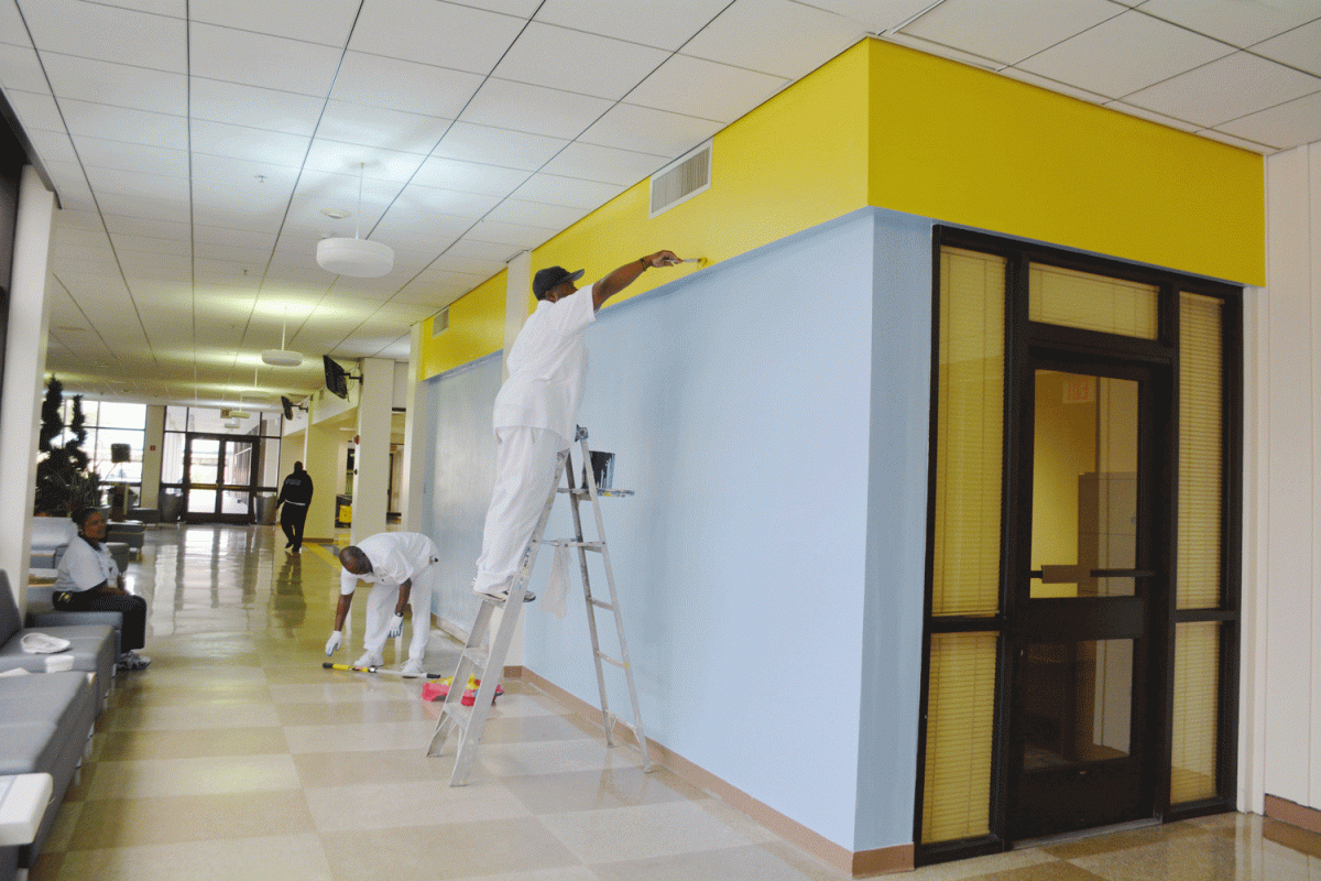 Southern University custodial workers paint the wall to be used for the recognition of student leaders.