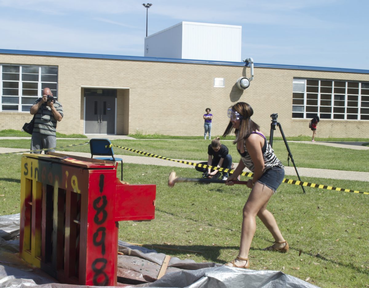 Southern University athlete,Fabiola Parra, gleefully releases frustration on an old piano during the Piano Smashing hosted by Phi Mu Alpha Fraternity,March 17.