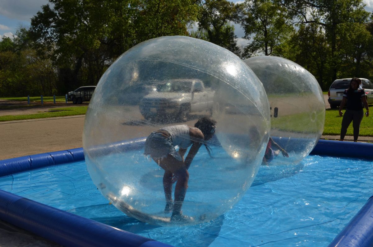 Students attend the Reslife Week Carnival in front of Old Jones and participate in the walk on water.