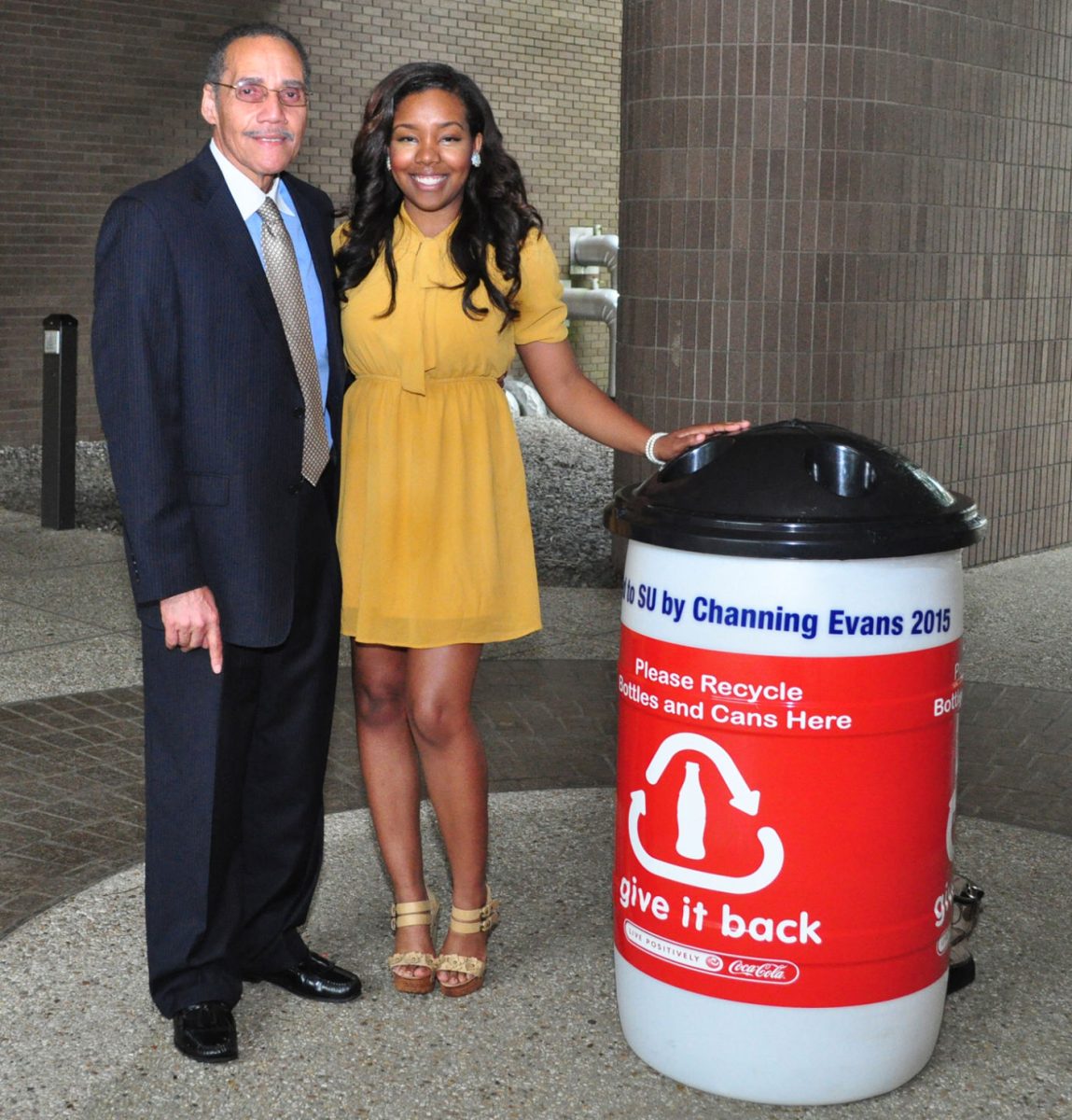 Chancellor Flandus McClinton and ambassador Channing Evans pose together next to one of the new Coca-Cola recycling bins.