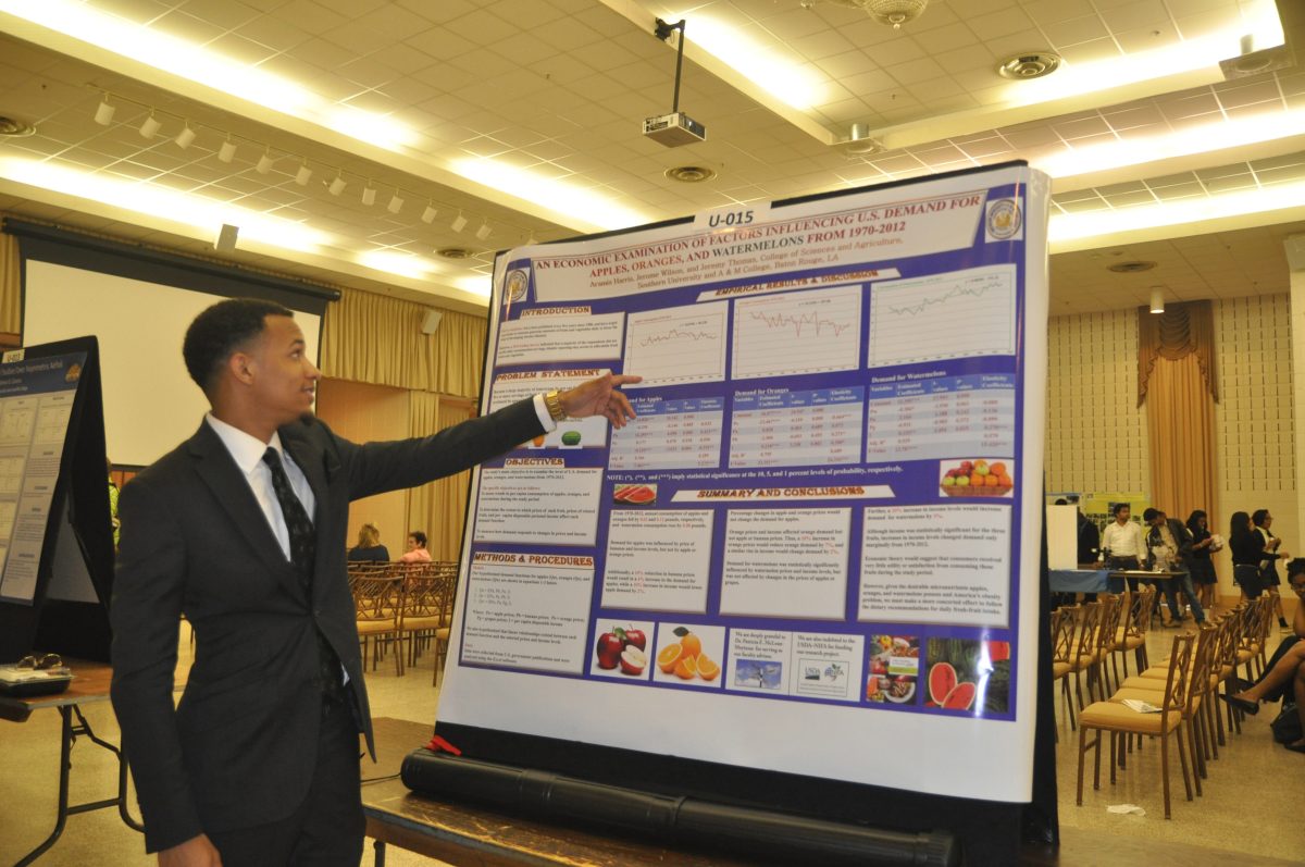 Aramis Harris, a senior agricultural economics major, from Washington, LA explains his substainability project at Southern's Substanability Demonstration held in the Collition Ballroom.