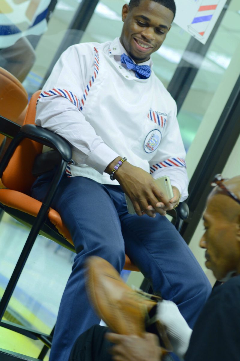 Southern University Barber, Willie McCorkle, gets his shoes shined during the Another Refined Gentleman event held in the Student Union on Wedneday August 19.