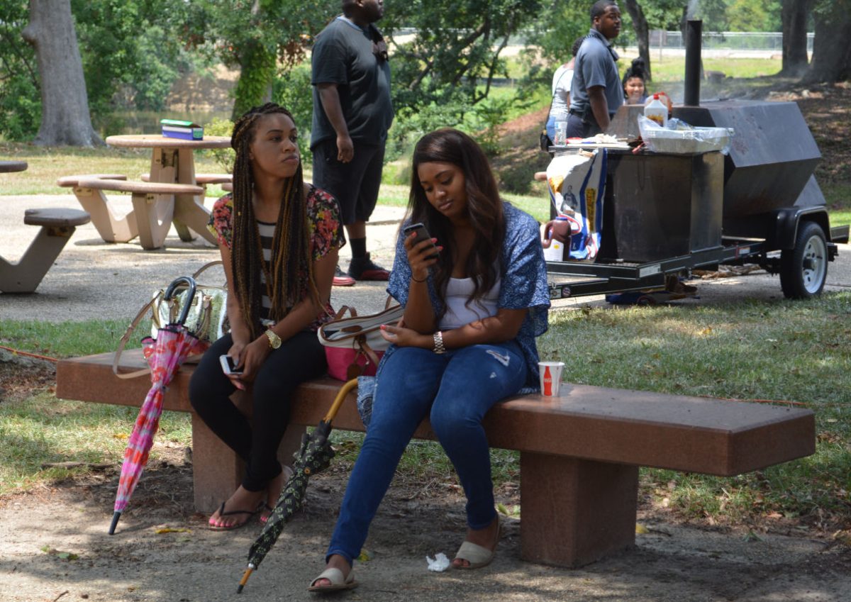 Two Southern University students relax in the shade during the Welcome Back Yard Block Party held the Student Union hosted by the Southern University Office Of Student Life.