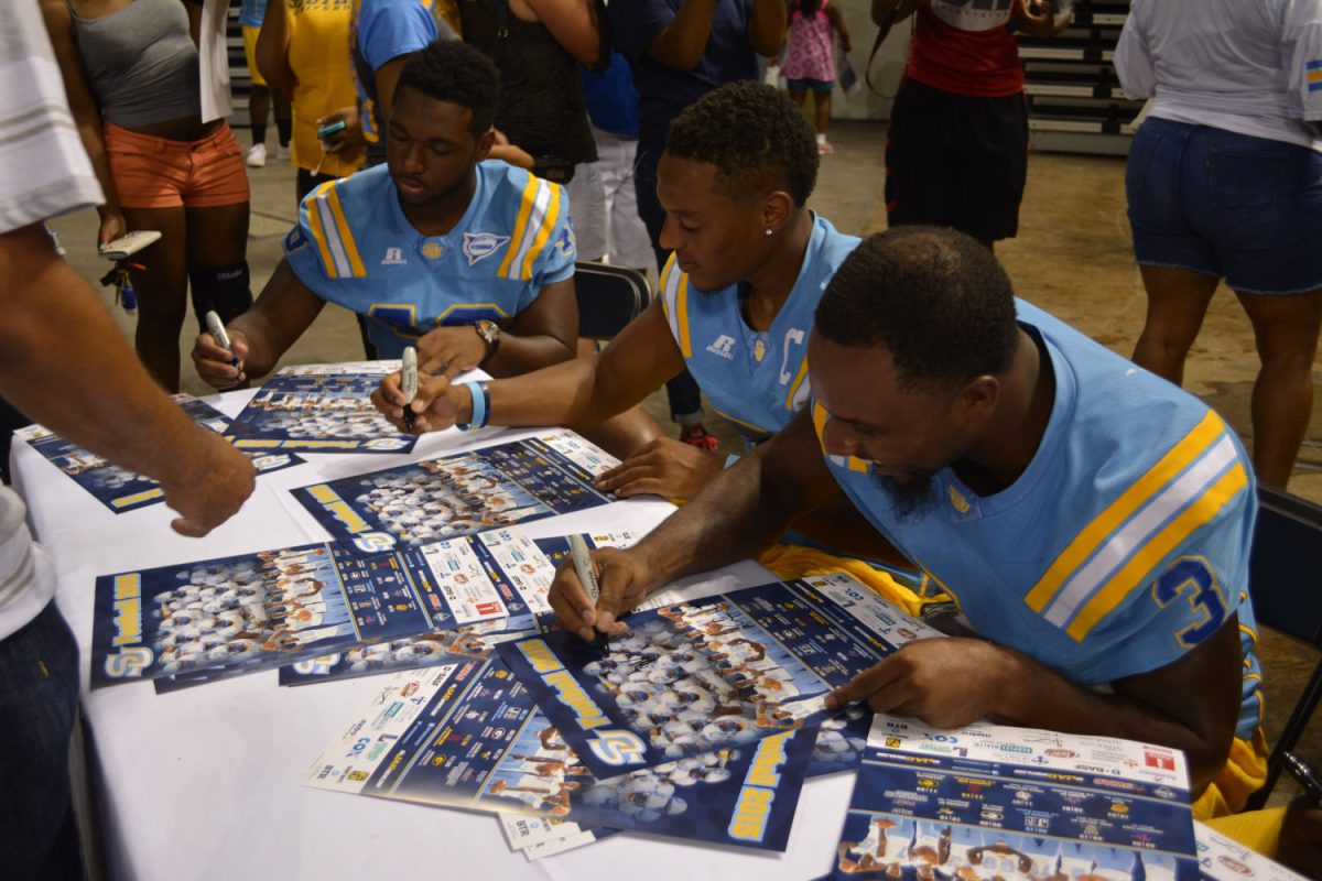 Southern University Football players sign autograpghs during Fan Fest meet and greet in the F.G. Clark Activity Center.