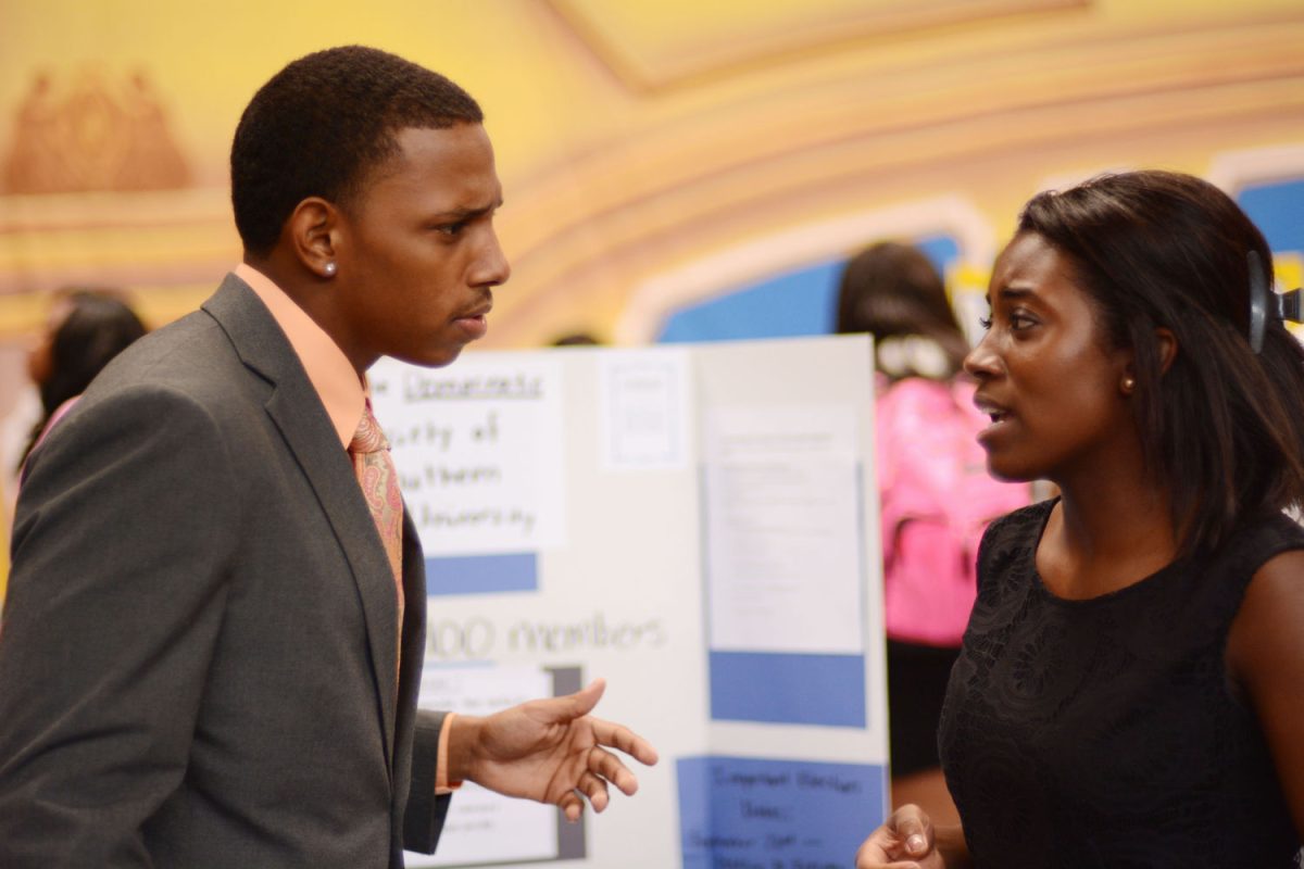 Southern University Graduate Teaching Assistant, Biology, M.S. and President of the Democratic Society of Southern University (DSSU) Angelle Bradford speaks with Junior Finance major Diarra Bryant about the educational and proffetianal benefits as well as the revamping of DSSU during the Organization Fair held in Seymour Gym.