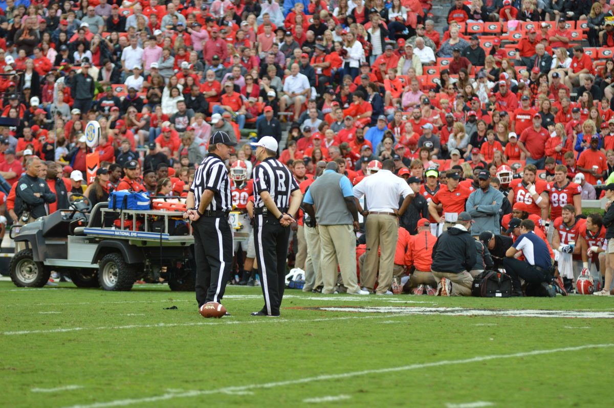 Coach Dawson Odums and staff looks on as The University of Georgia and Southern University medical staff tends to an injured Devon Gales, who suffered multiple neck fractures on september 23 in Sanford Stadium.