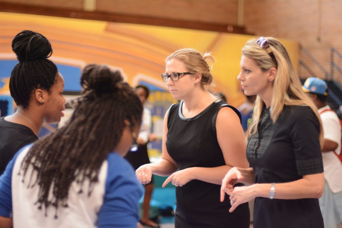 Junior Achievement of Great Baton Rouge &amp; Acadiana Education Managers Jennifer Scripps (LEFT) and Jamie Doming (RIGHT) answer students' questions about what volunteering experiences they have to offer during Organization Fair held in Seymour Gym.