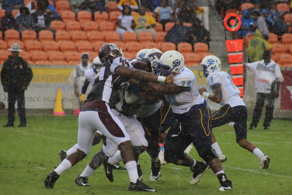 SU offensive linemen fight to extend a play against Texas Southern. Despite the torrential rain fall, the Jaguars were able to stay balanced and defeat the Tigers in BBVA Compass Stadium on Saturday, October 24.