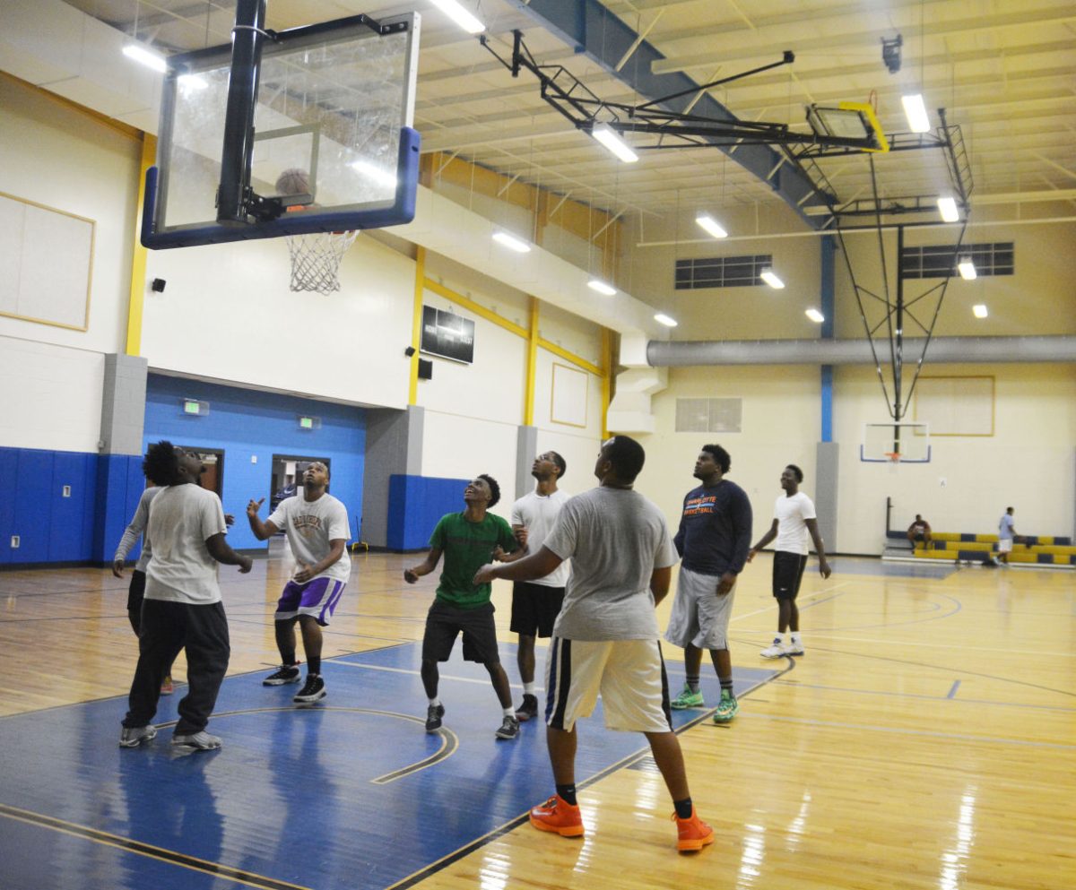 3 on 3 tournament players anticipate rebounding the ball after an attempted 3 pointer late friday night during the "kin of the court" tournament