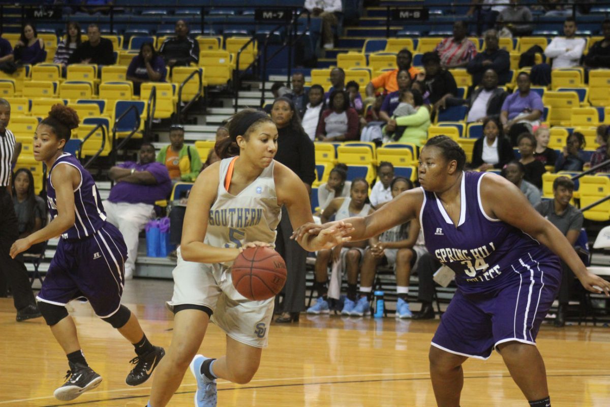 Senior point guard, Jadea Brundidge charges past oposing player during womens Southern vs Spring Hill basketball game.