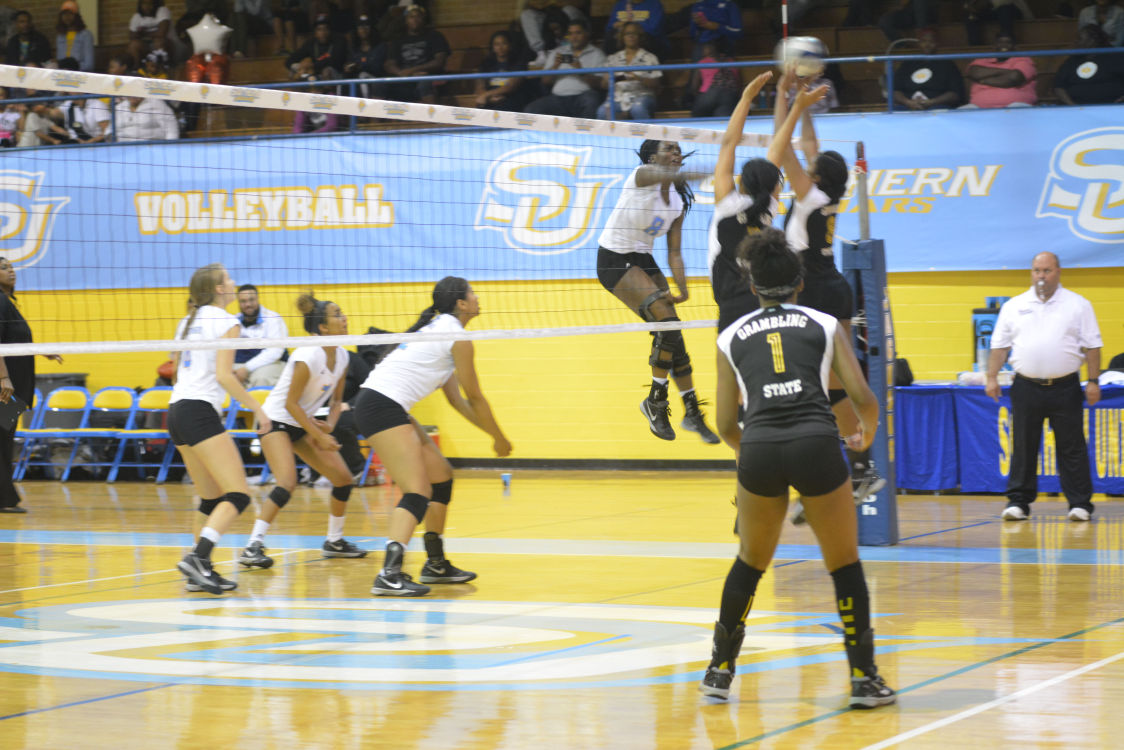 Senior middle blocker, Chinasa Ekweariri, strikes the ball across the net during 3-0 win against Grambling State University.