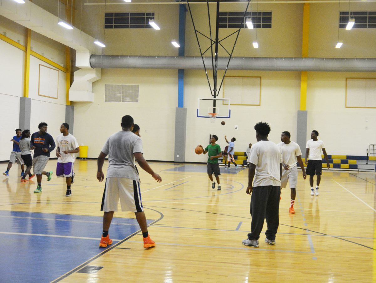 3 on 3 tournament contestant dribbles up the court looking for an open pass during the 1st round of the "king of the court" tournament which took place on Friday November 5th at the intramural Sports complex .