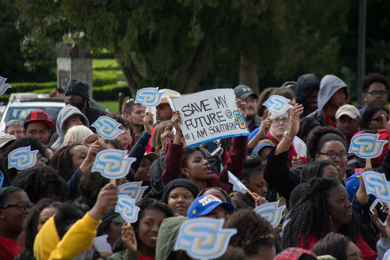 Sophomore business markering major,Darby Smith, stands holding her sign amongst other ralliers at the Bring Higher Education All Together (#BRING H.E.A.T.) rally on Wednesday, February 24 on the steps of the Louisiana State Capitol.