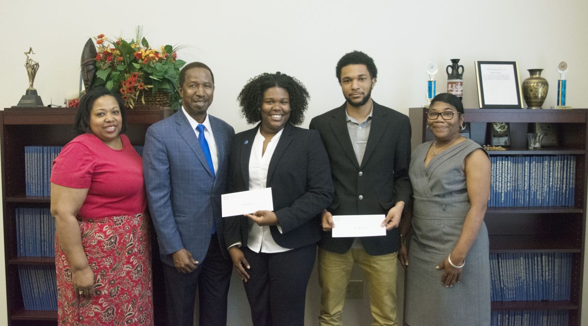 Professor and Chair of the Physics department Dr. Diola Bagayoko presents freshman math and physics major from Minneapolis, Minnesota Jonalyn Fair and freshman civil engineering major from Carbondale, Illinois, Joyner Deamer with academic scholarships on Wednesday March 30.